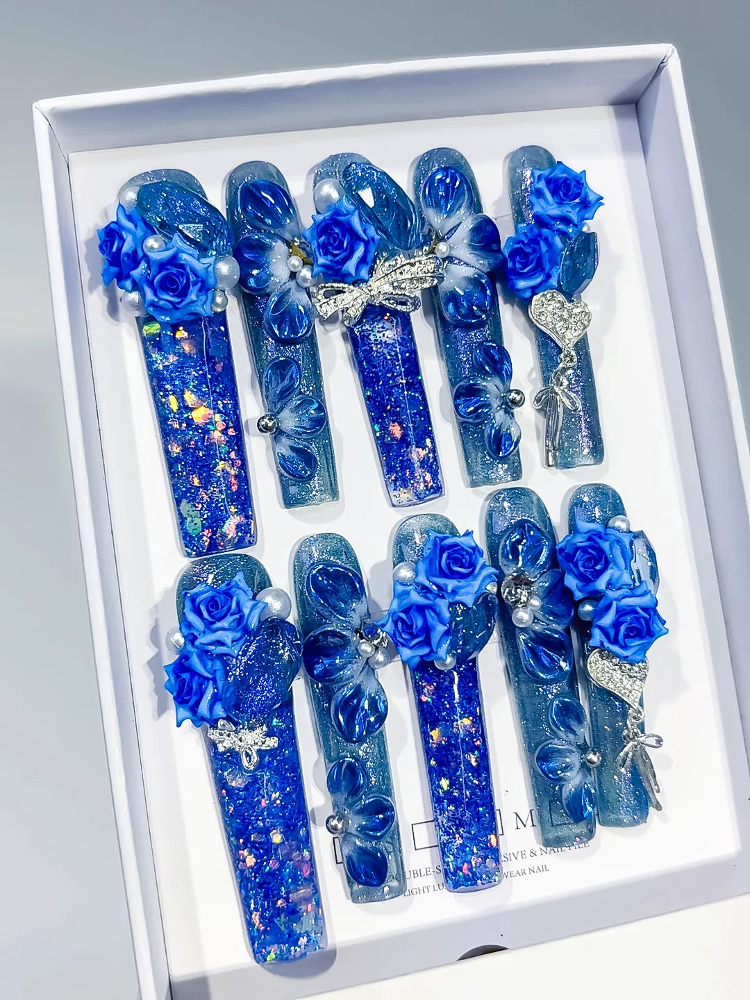 Blue Silver Multicolor Glitter Rose Bow Heart Pearl Rhinestone 3D press on nails angled view