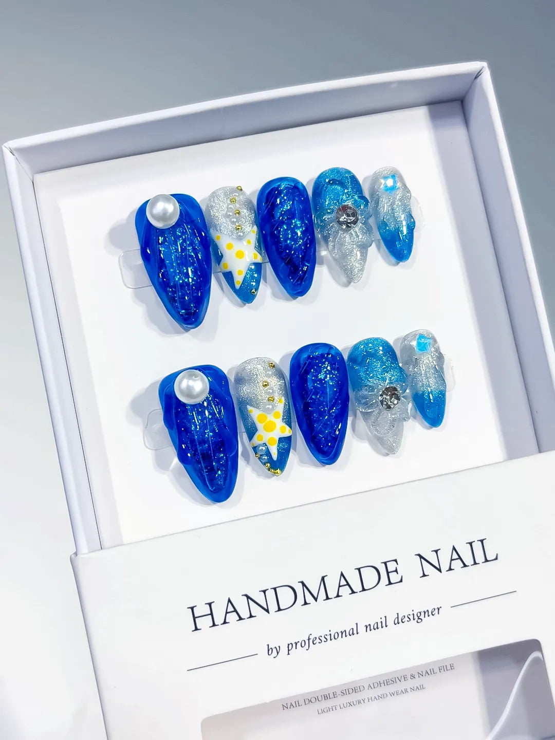 Blue Silver White Yellow Glitter Pearl Rhinestone Bow 3D press on nails angled view