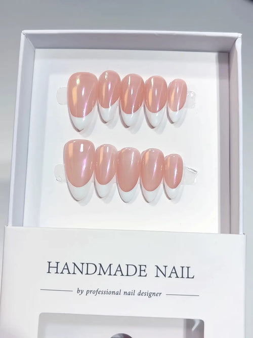 Pink chrome medium almond handmade press on nails with aurora French tips in a white designer box.