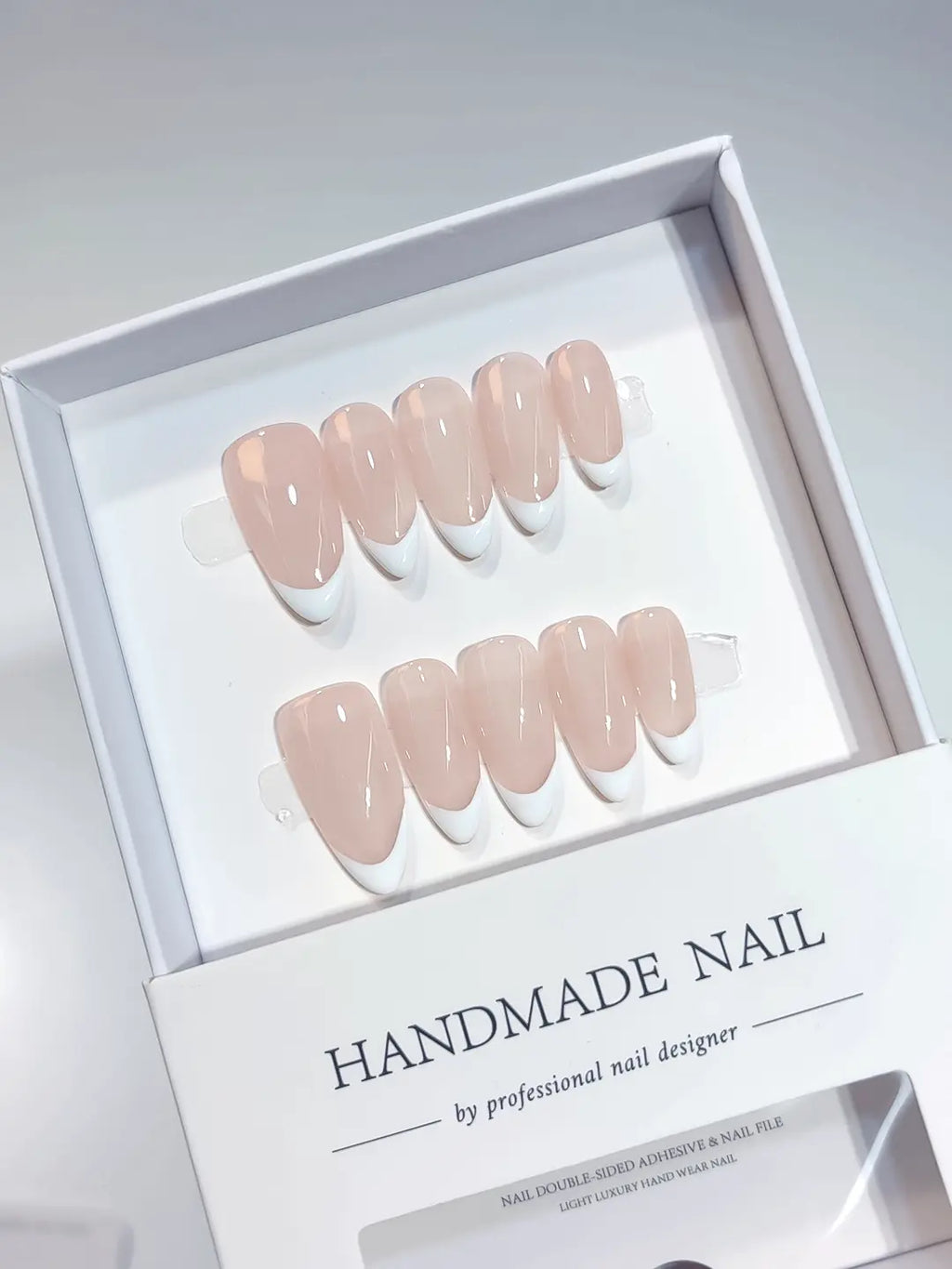 Side view showing the natural curvature and glossy finish of medium almond handmade press on nails with french design.
