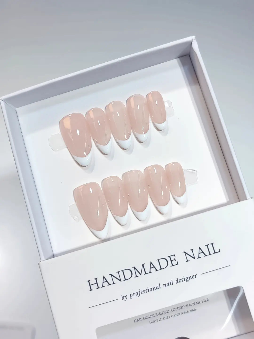 Side view showing the natural curvature and glossy finish of medium almond handmade press on nails with french design.
