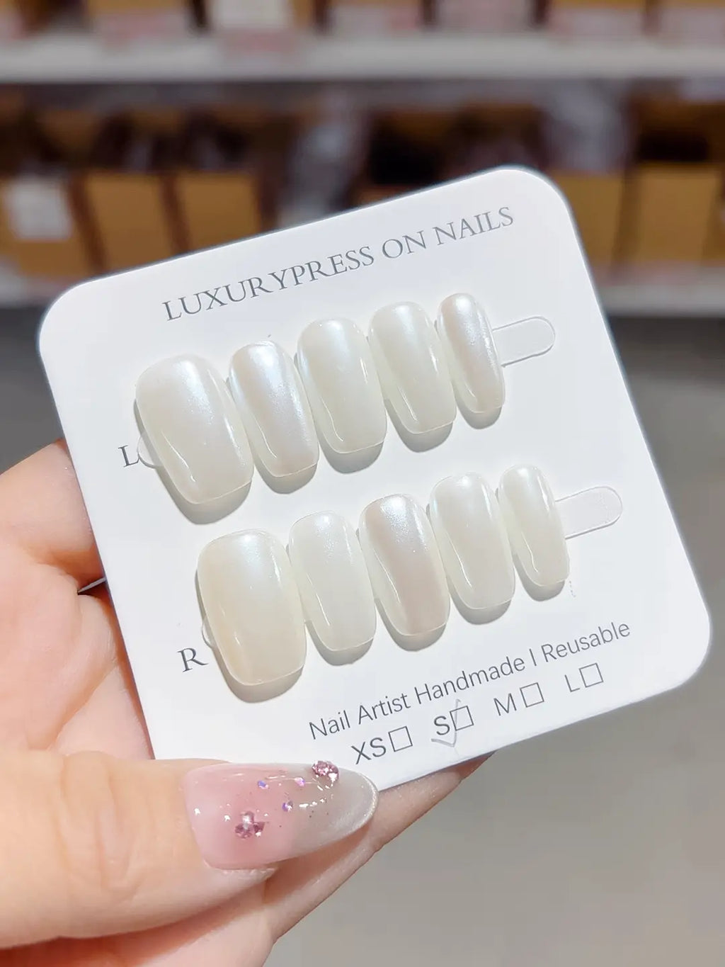 angled view of white glazed handmade press on nails with natural sheen
