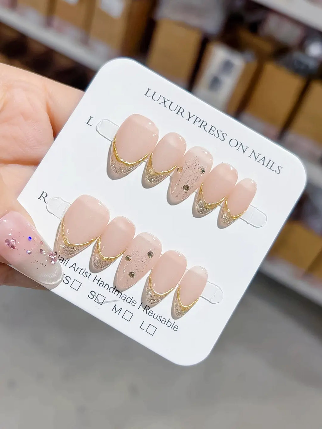angled view showing metallic gold V-tips and glitter, handmade press on nails