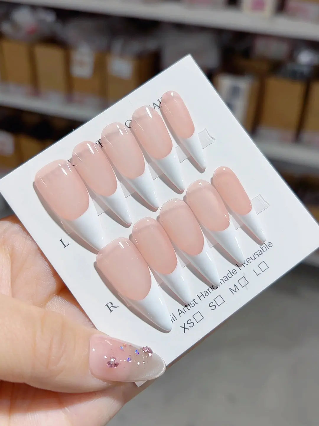 closeup of tapered tips on handmade press on nails, long stiletto French