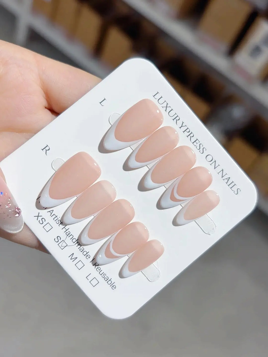 elegant nude french handmade press on nails with white double lines, angled perspective