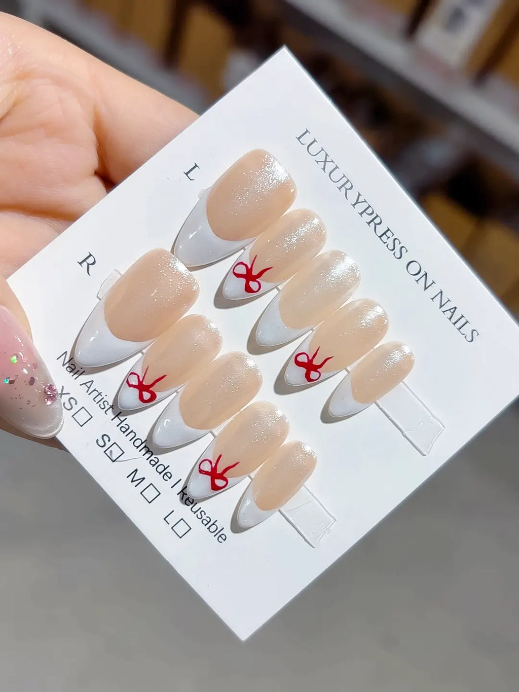 full set closeup, natural nude french with subtle glitter and bow detail, handmade press on nails