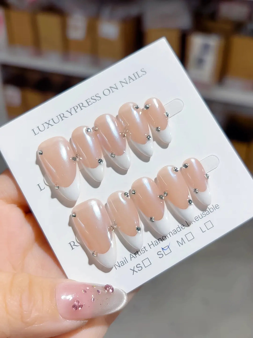 handmade press on nails, full set showing almond shape, glossy nude finish, and evenly placed rhinestones