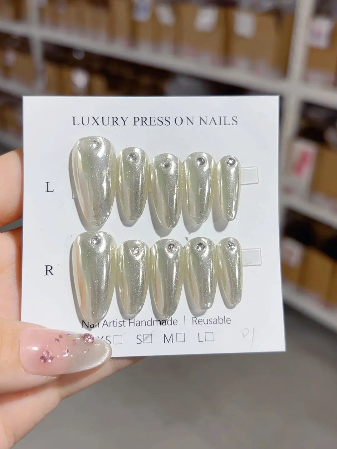 handmade press on nails long almond angled view silver with rhinestone detail