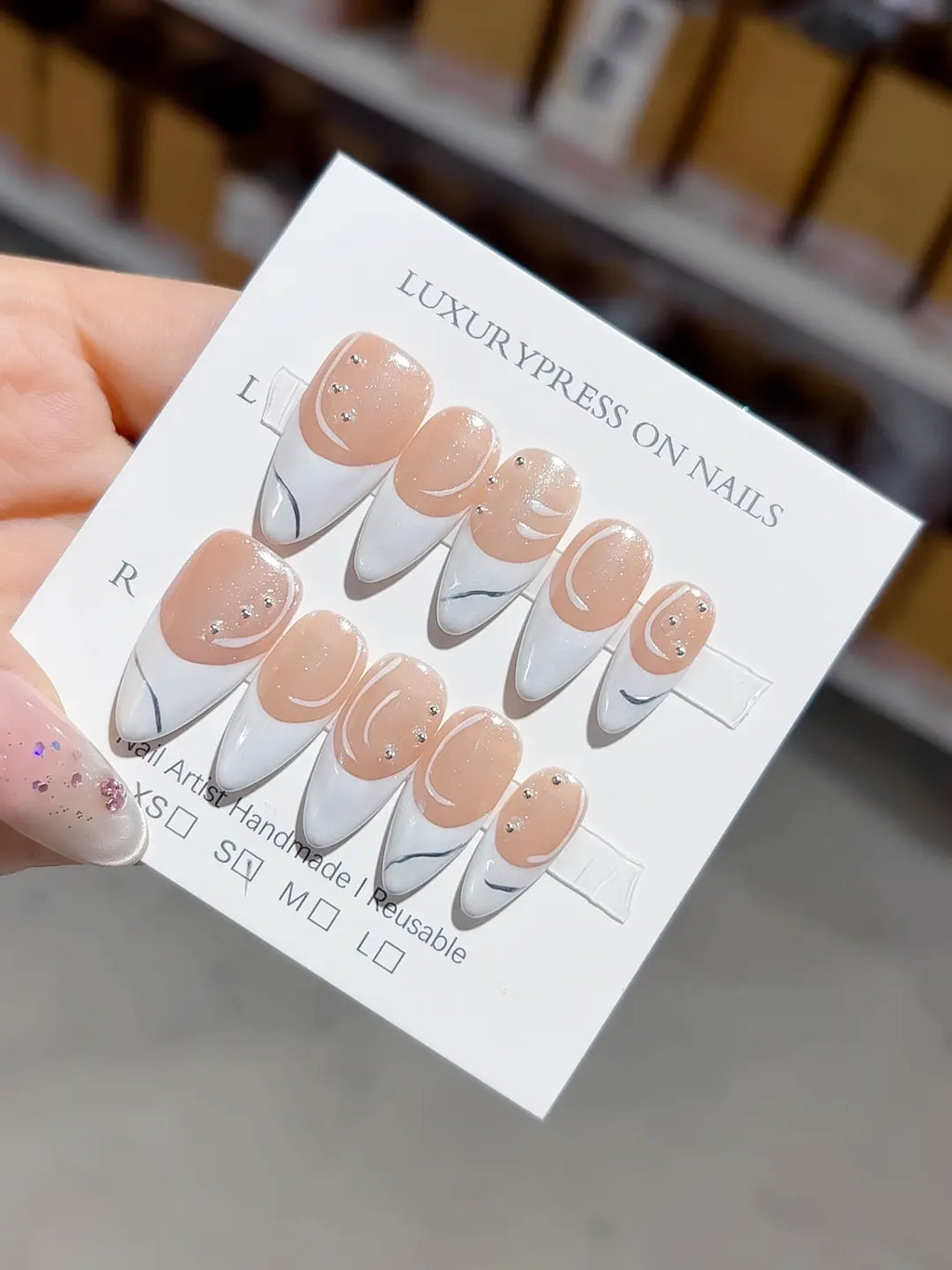 handmade press on nails, long stiletto layout highlighting french swirl and marble detail with glossy finish