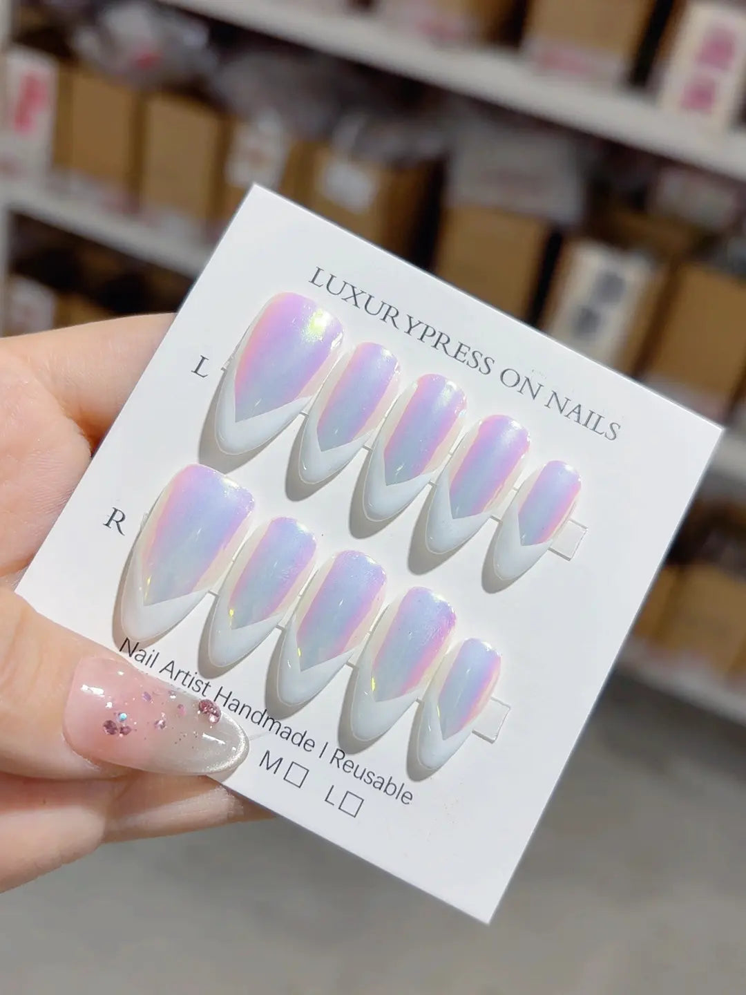 handmade press on nails medium almond angled view showing V French tip and shimmer