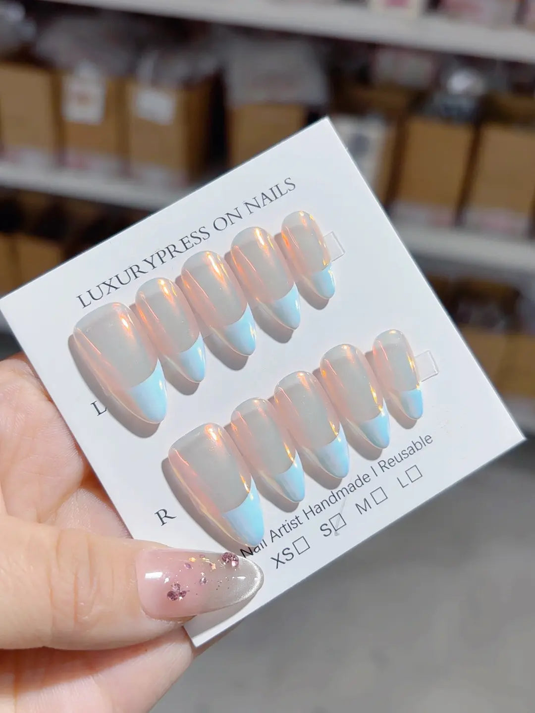 handmade press on nails medium almond angled view showing blue French tips and transparency