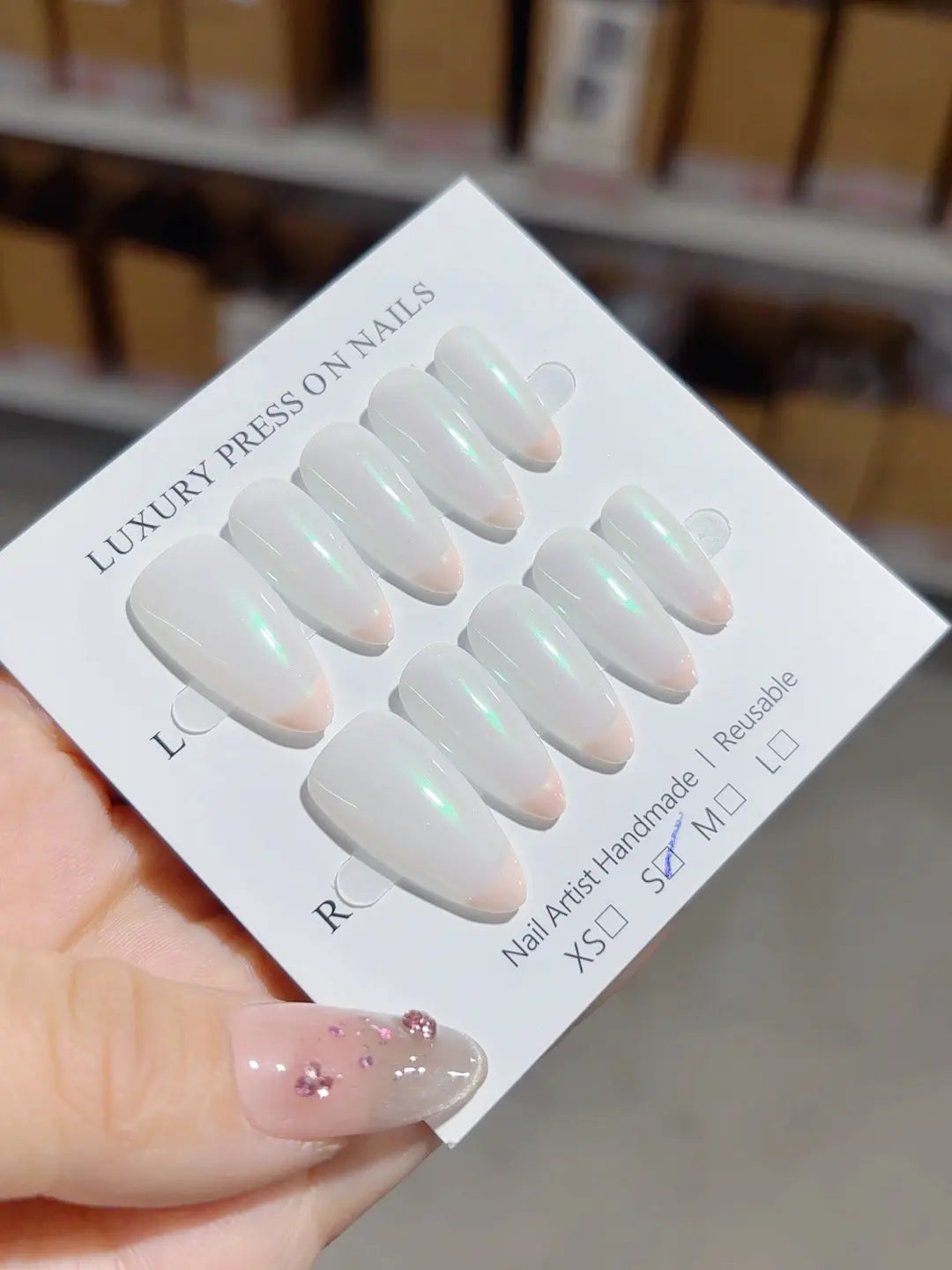 handmade press on nails medium almond white french with green aurora glow, angled view
