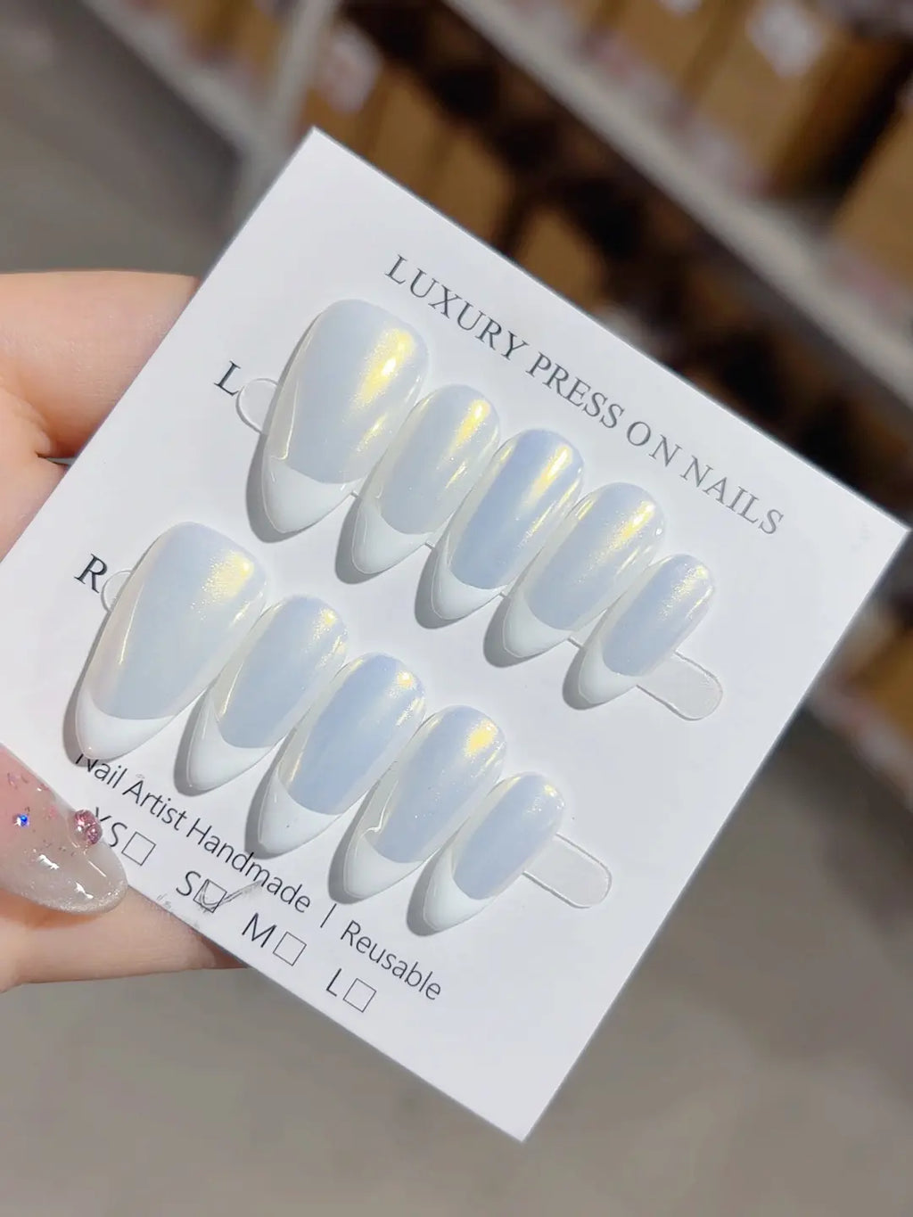 handmade press on nails medium almond white french with yellow aurora shine, angled view