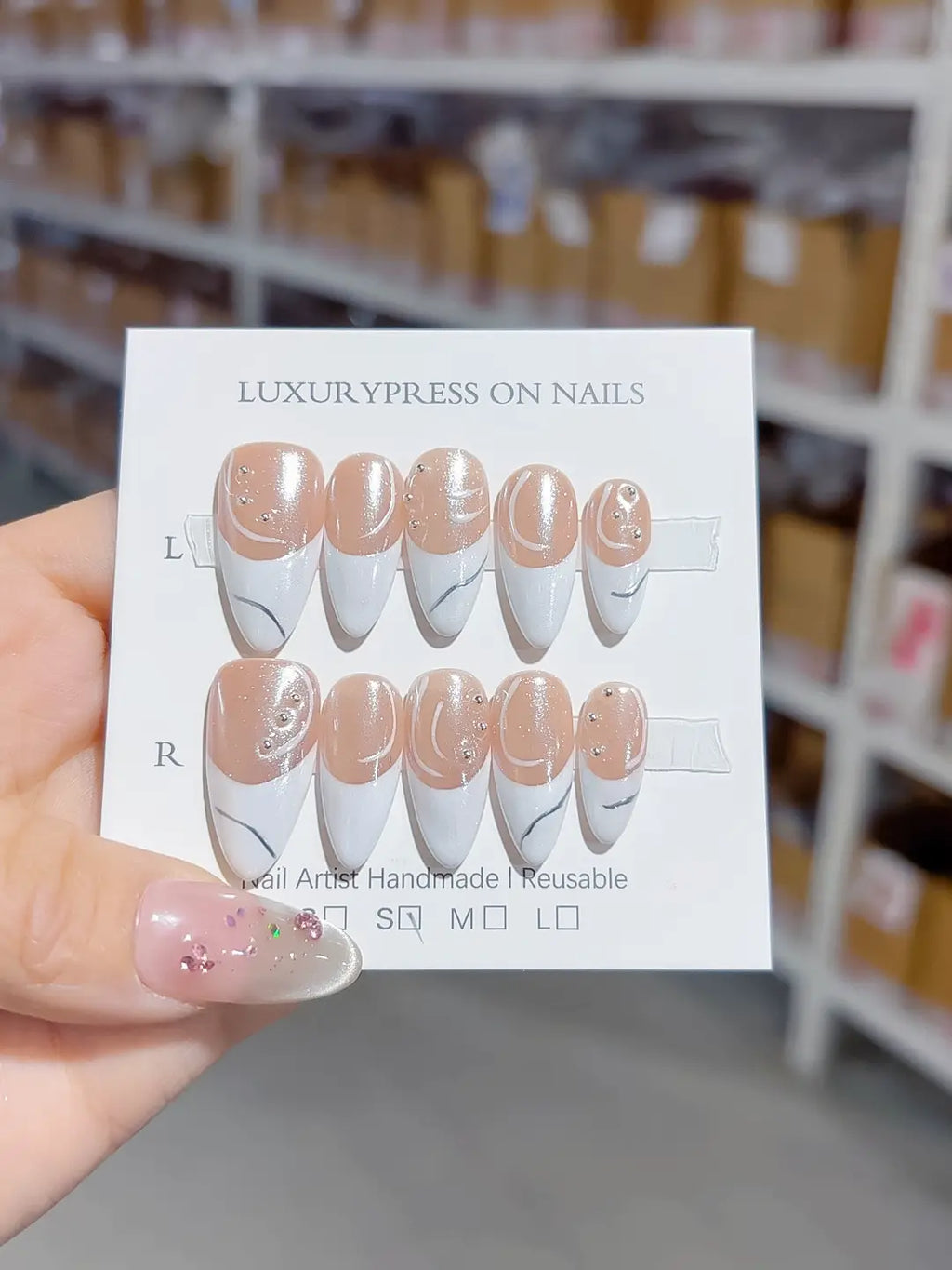 handmade press on nails set, close-up of glitter nude base, white french tips and 3D rhinestone accents