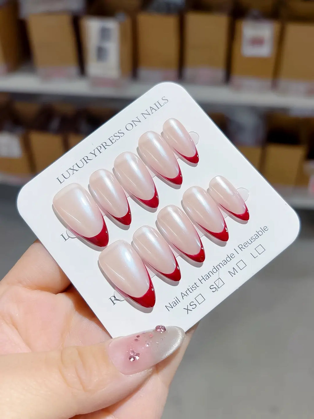handmade press on nails set, close-up of medium almond red french design on nude base