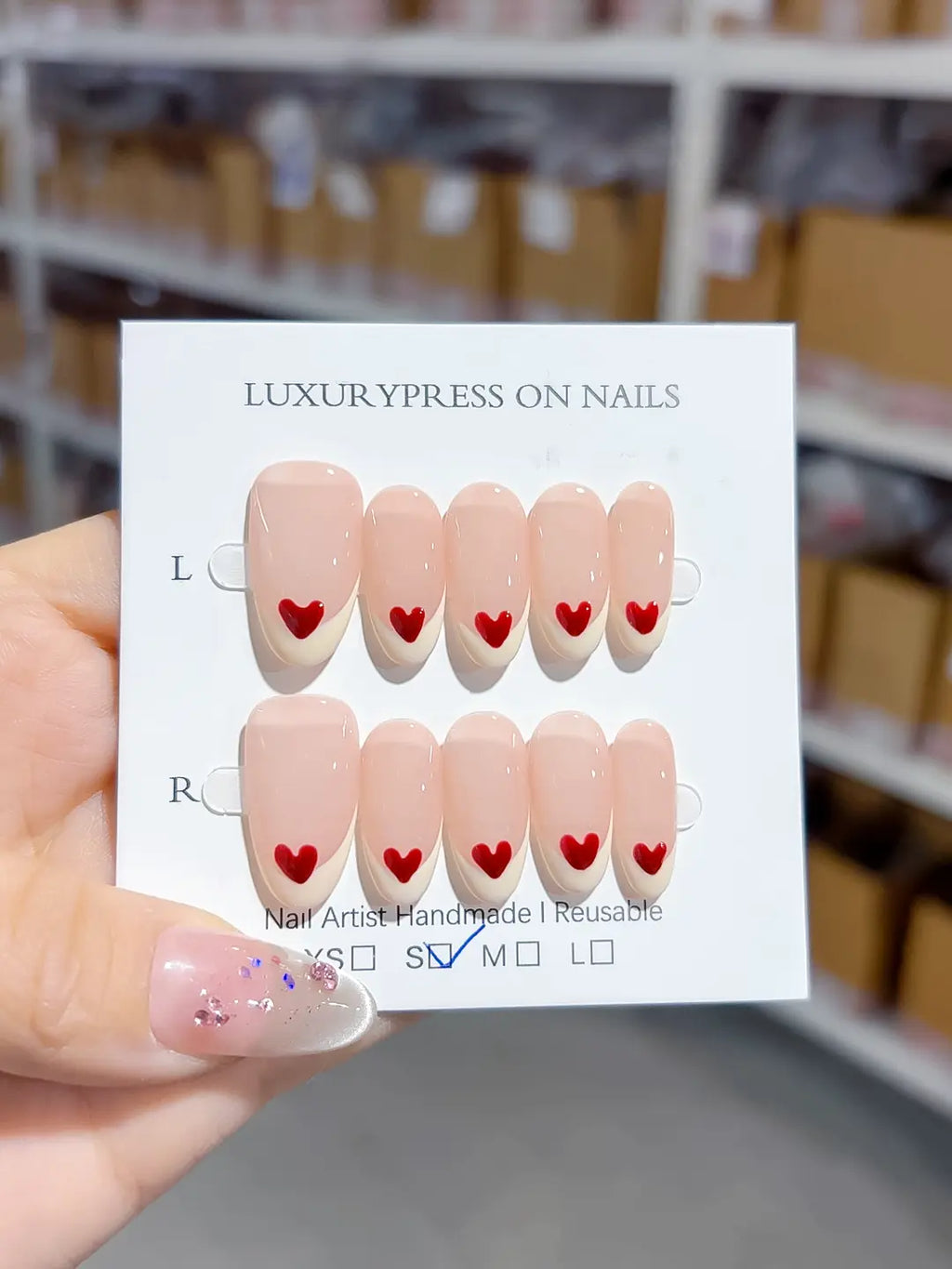 handmade press on nails set, close-up of medium oval nude base with white french and red hearts