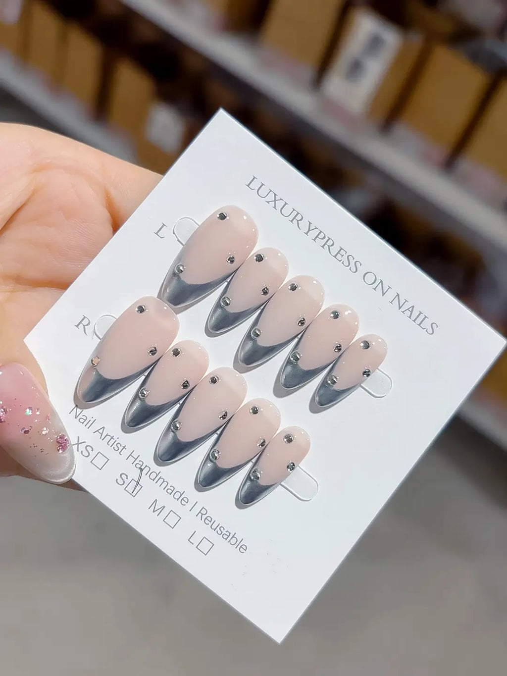 handmade press on nails set, close-up of nude chrome french with evenly placed rhinestone accents