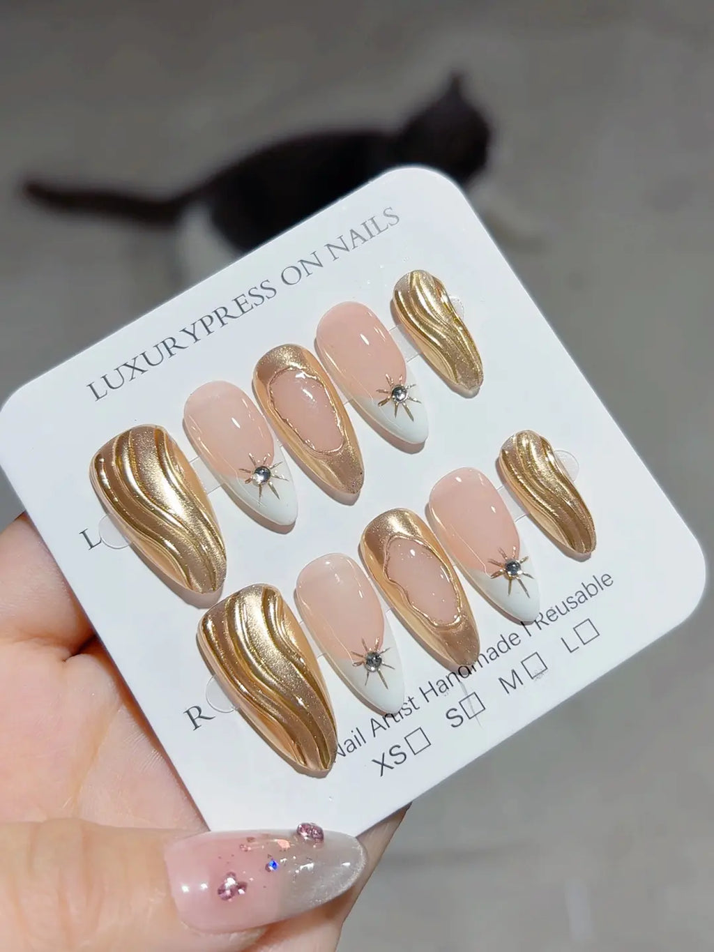handmade press on nails with luxury gold swirl and white French angled view