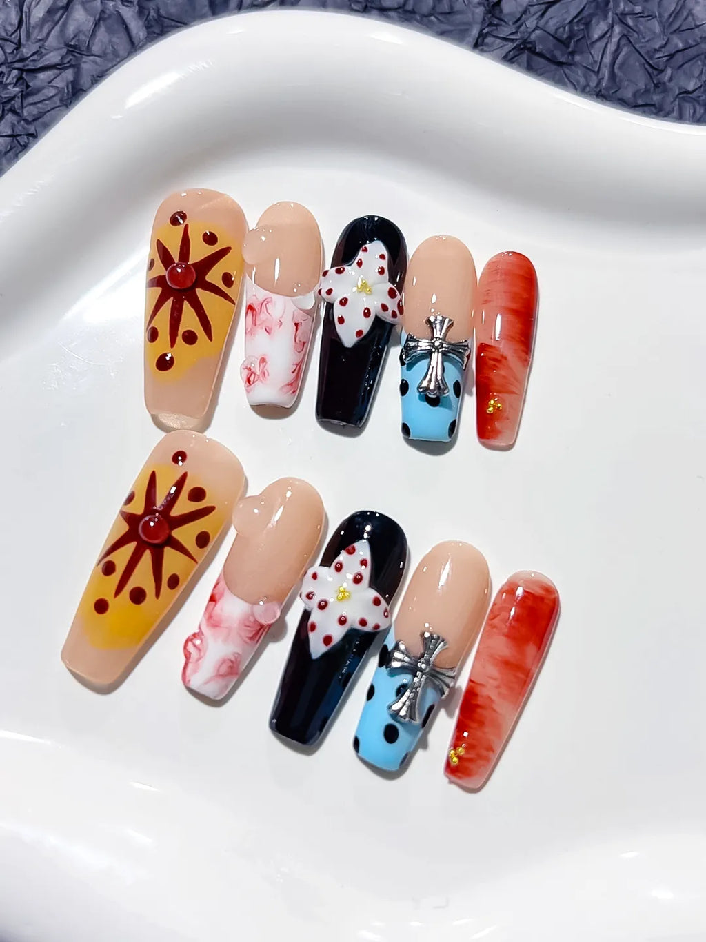 Nude Black Blue Orange Abstract Flower Cross press on nails angled view