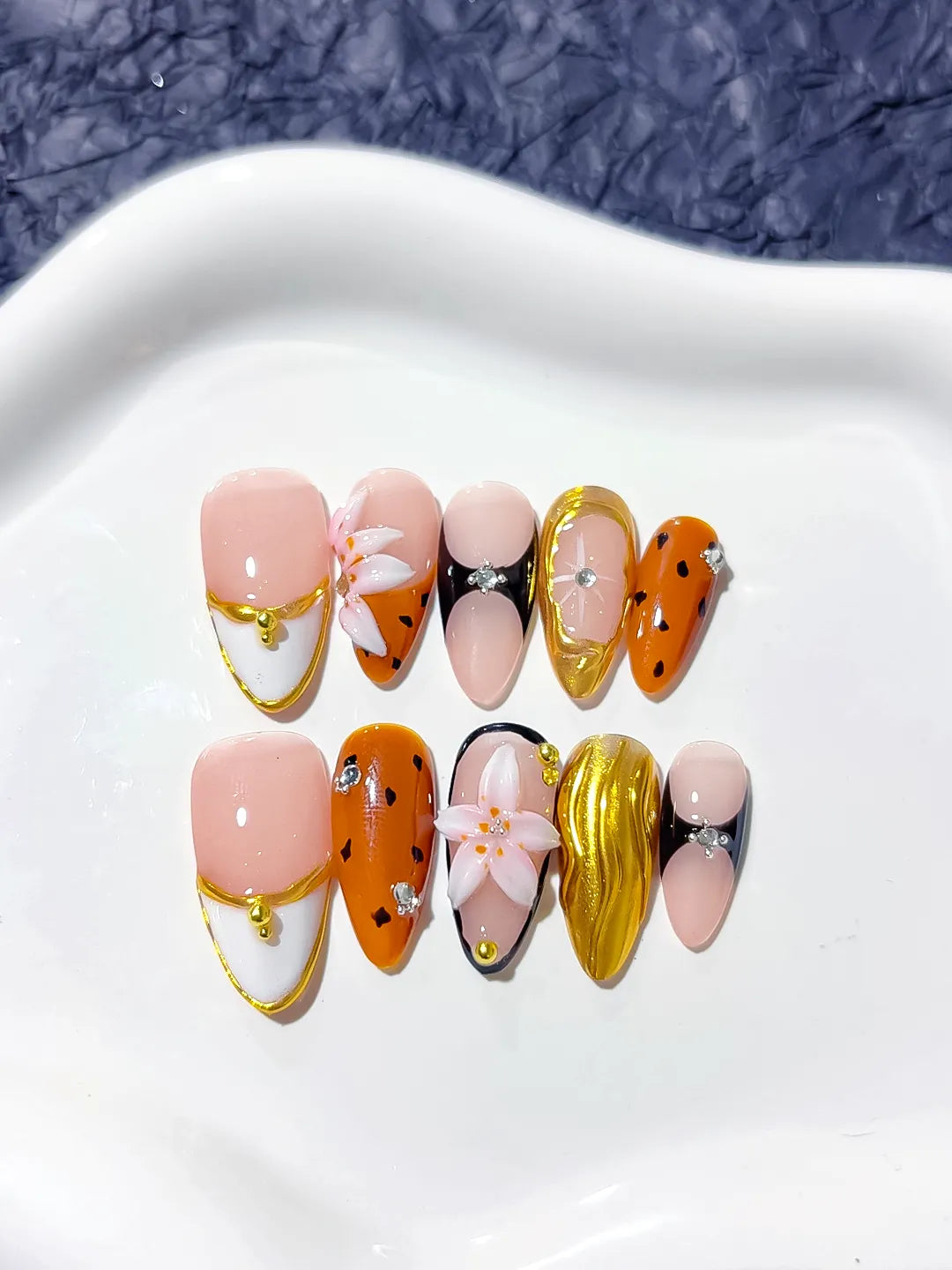 Nude Orange Gold Black Abstract Flower Metallic press on nails angled view