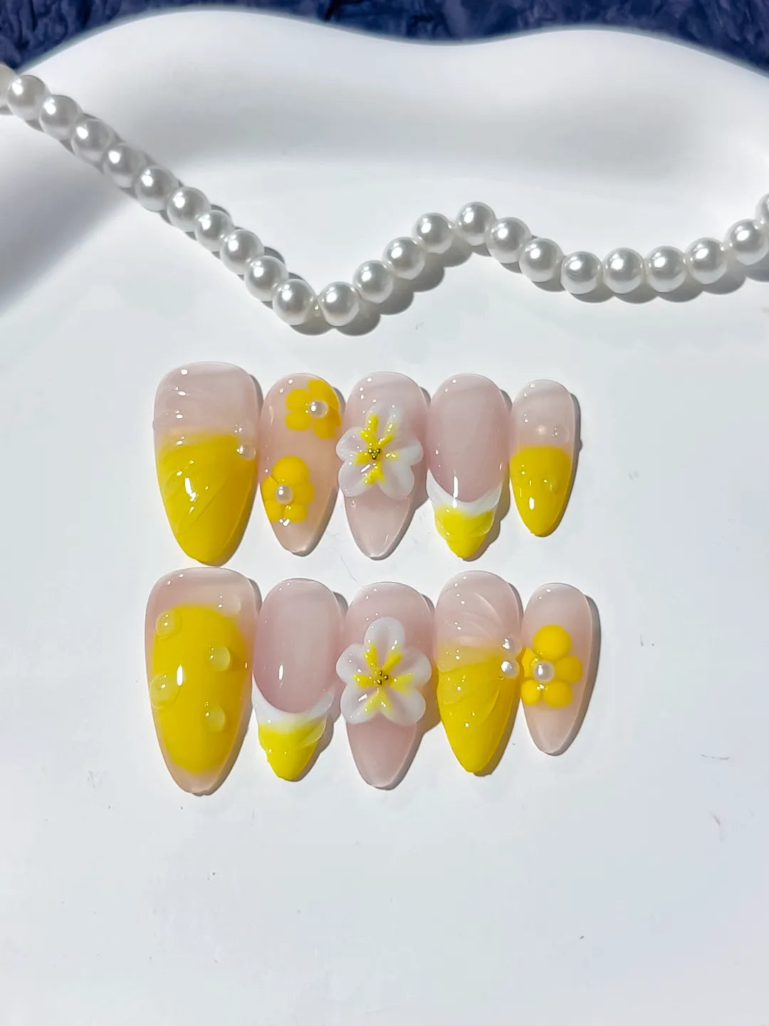 Nude Yellow French tip Flower press on nails close up