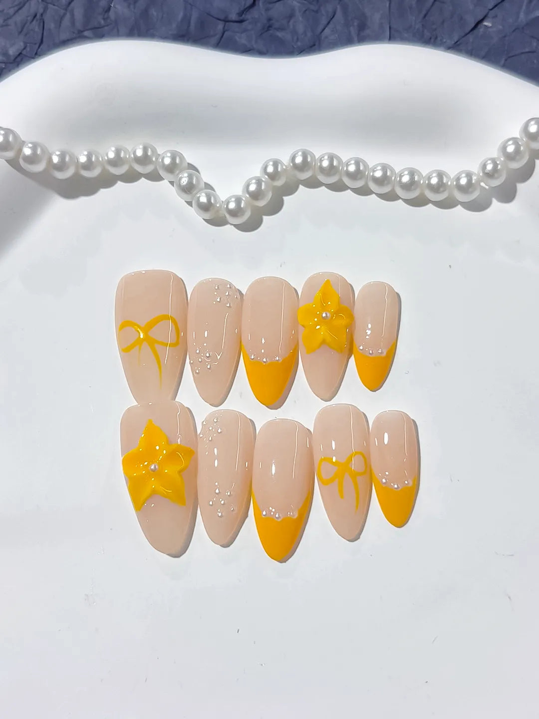 Nude Yellow French tip Flower Bow press on nails detail view
