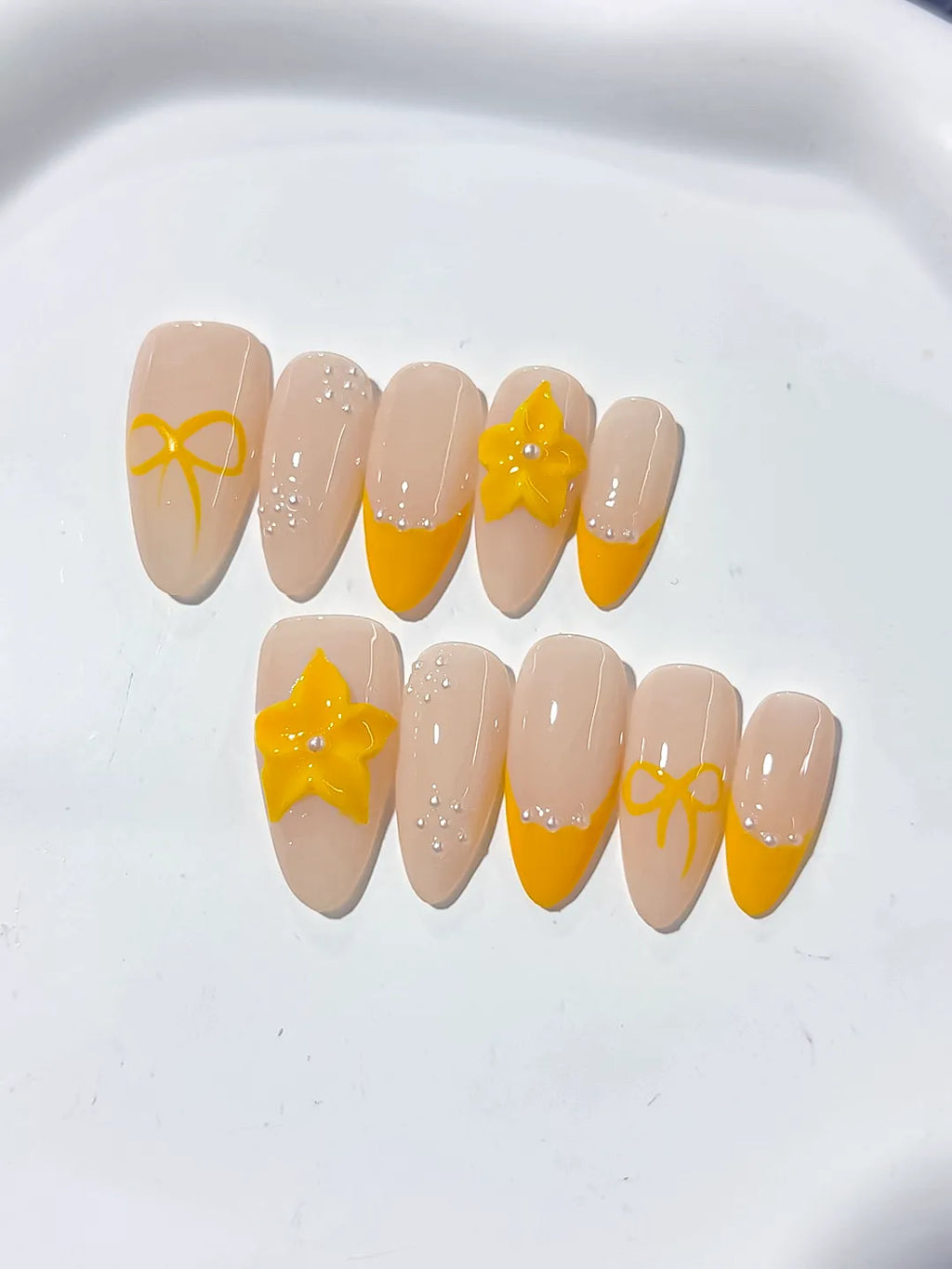 Nude Yellow French tip Flower Bow press on nails close up