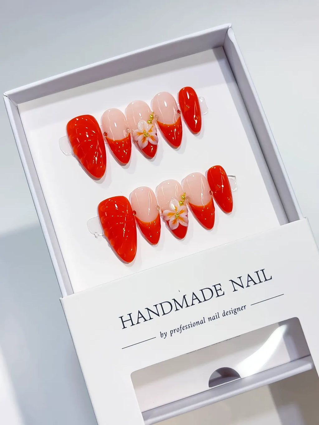 Nude Red Gold French tip Flower Shell press on nails angled view