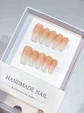 Set of handmade medium coffin press-on nails with an elegant peach and white ombre design. The gradient transitions smoothly, offering a chic and sophisticated look suitable for any occasion. Perfect for a natural yet stylish manicure.
