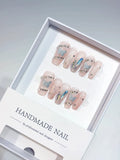 Elegant Nude Coffin Medium Handmade Press On Nails, featuring shimmering silver glitter butterflies, dazzling rhinestones, and multicolor holographic shards. This design creates a luxurious, sparkling look, perfect for a sophisticated yet whimsical aesthetic. Ideal for retail display.