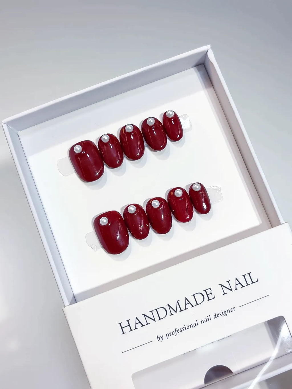 Red Solid color Pearl press on nails angled view