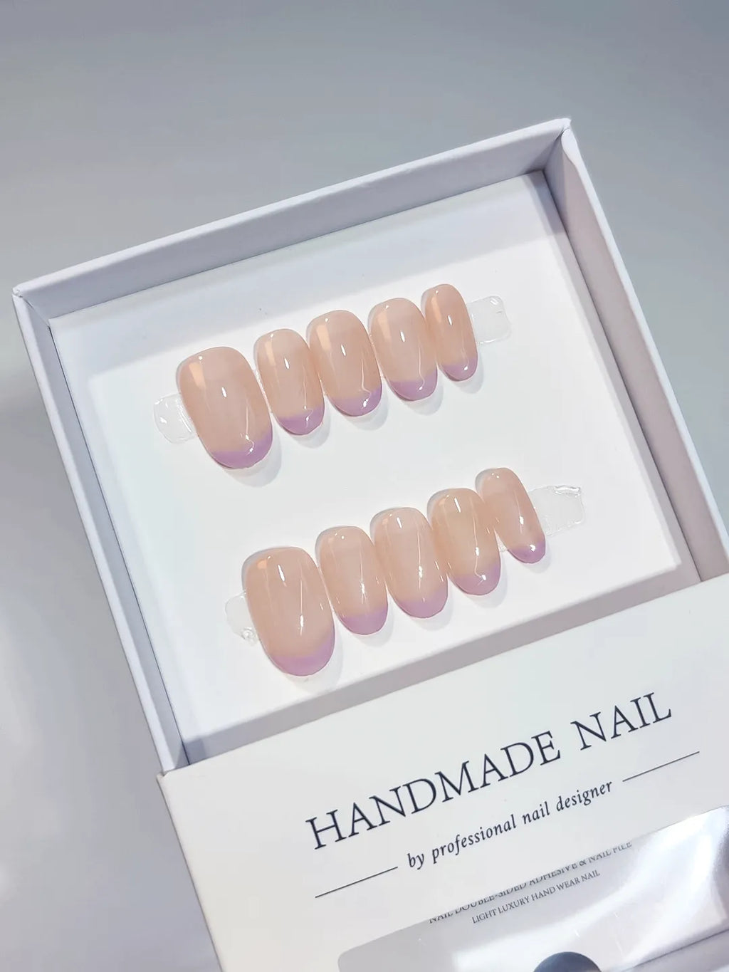Nude Purple French tip press on nails angled view