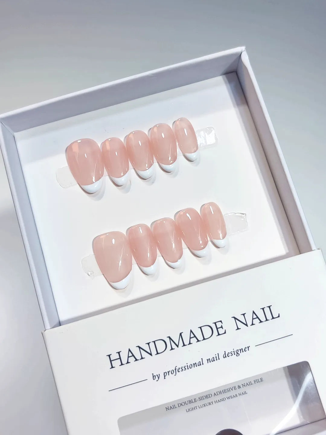 Handmade press on nails short almond nude with mini French tips, centerpiece view