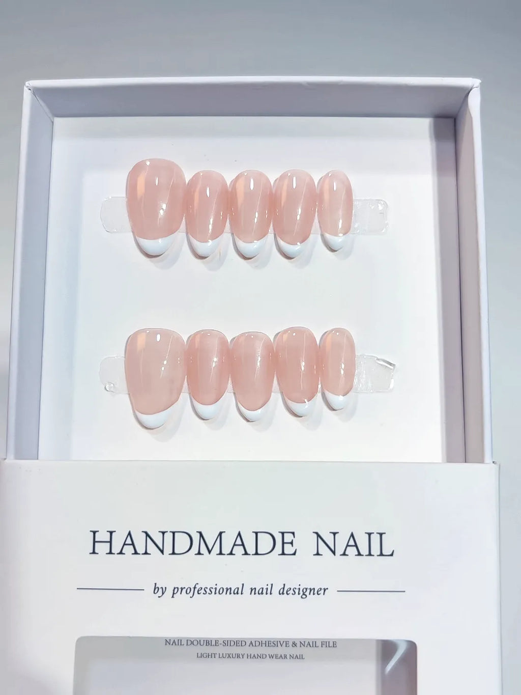 Handmade press on nails short almond nude with mini French tips, centerpiece view