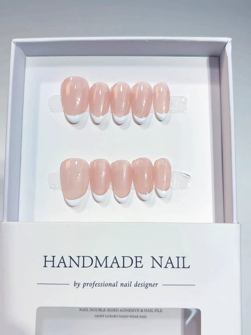 Handmade press on nails short almond nude with mini French tips, centerpiece view
