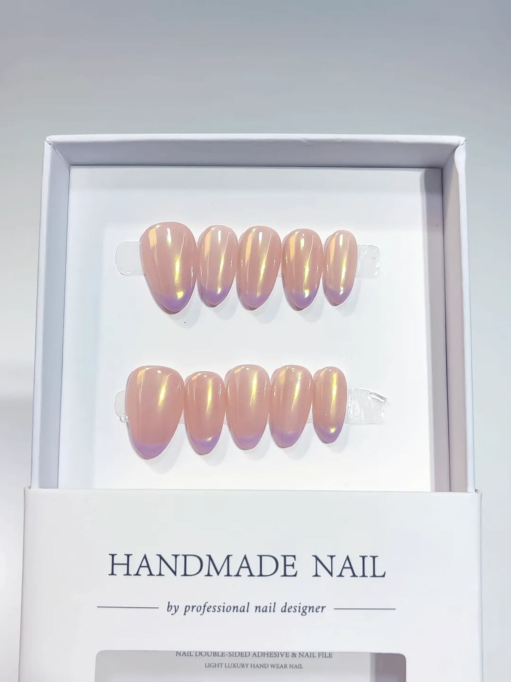 Handmade press on nails short almond nude with aurora shimmer, centerpiece view