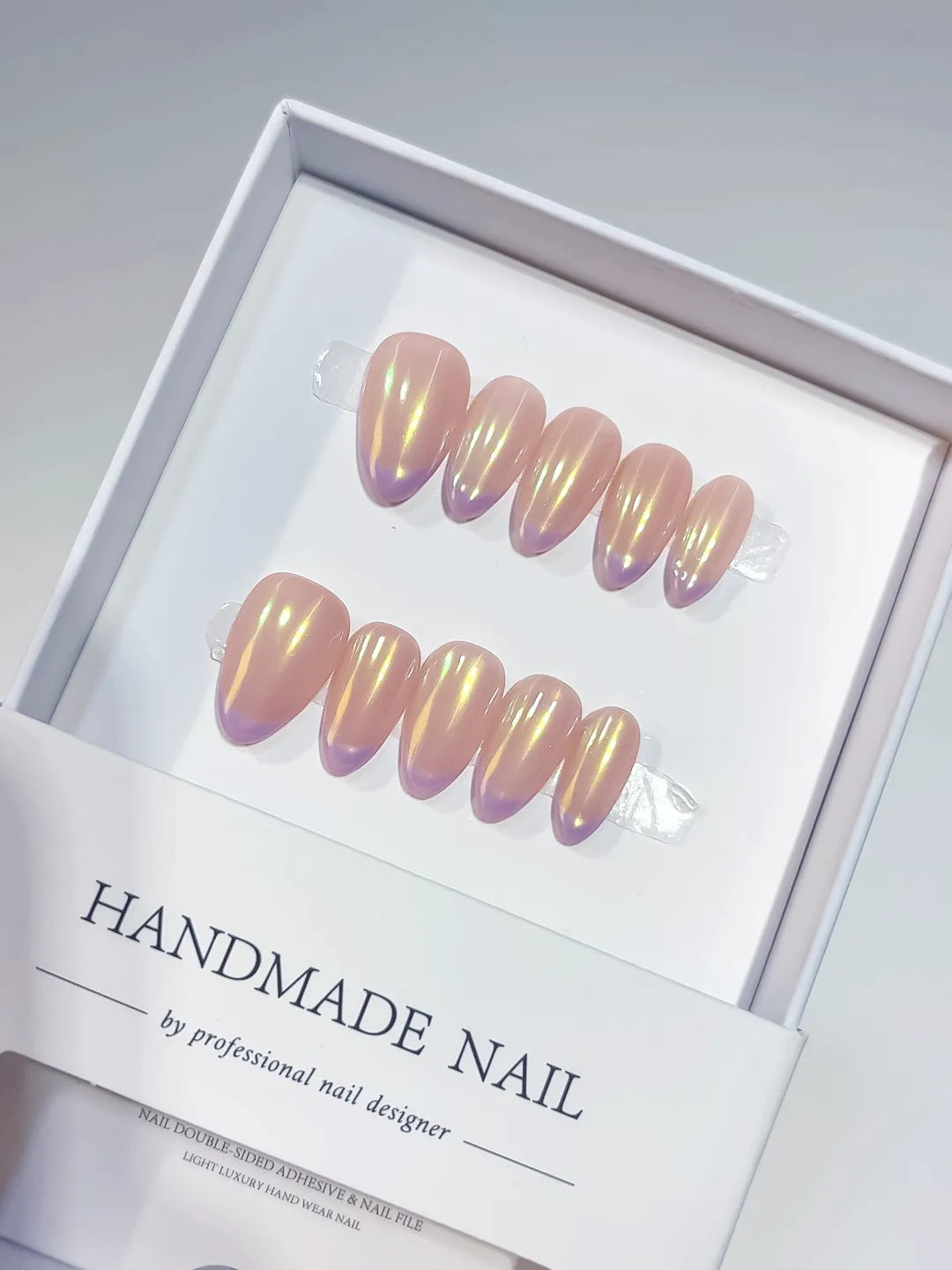 Handmade press on nails short almond nude with aurora shimmer, centerpiece view