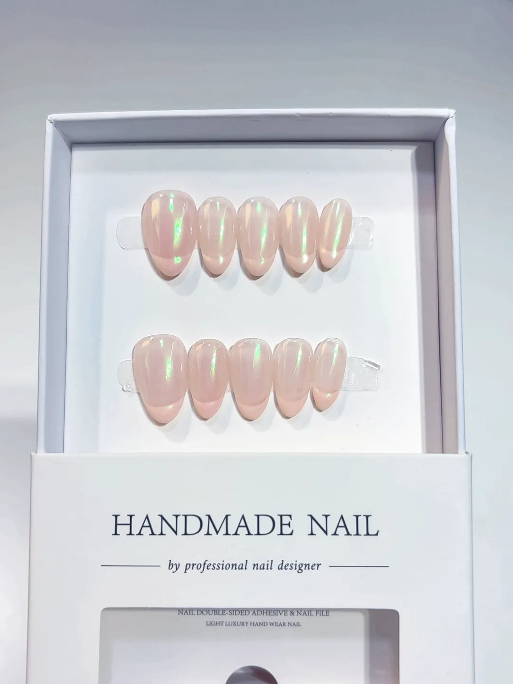 Handmade press on nails nude almond with green aurora shimmer, centerpiece view