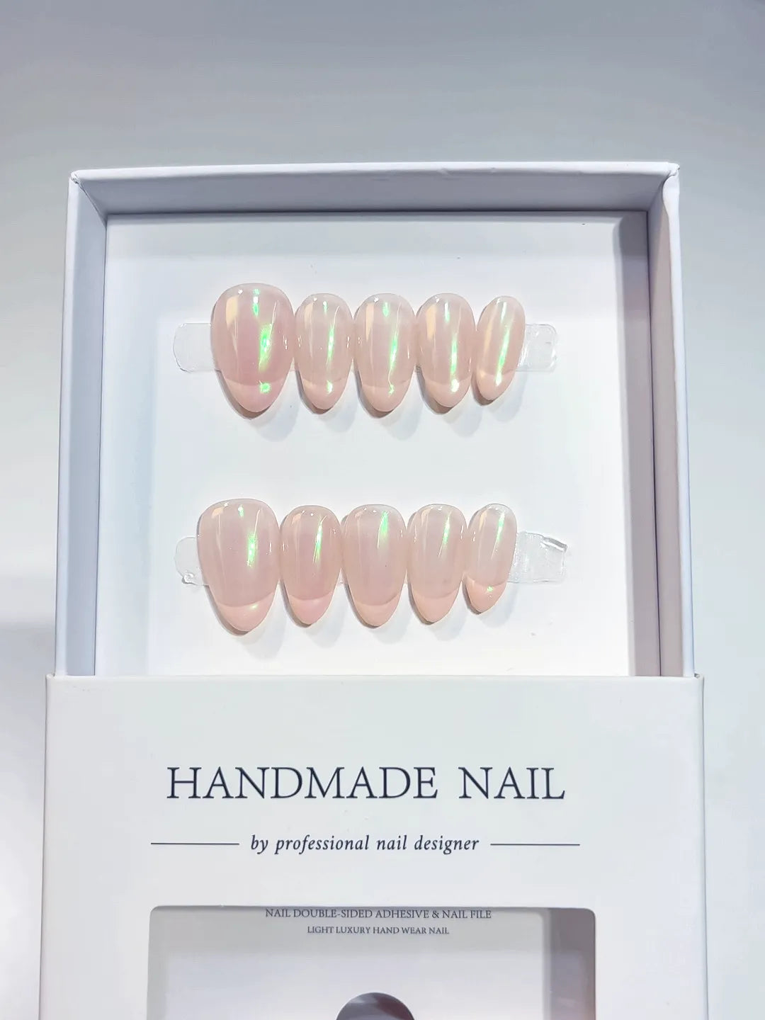 Handmade press on nails nude almond with green aurora shimmer, centerpiece view