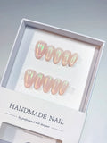 Handmade press on nails nude almond with green aurora shimmer, centerpiece view
