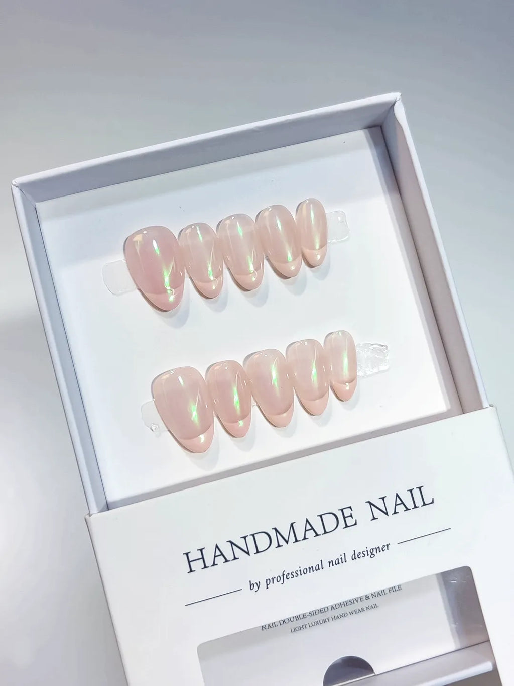 Handmade press on nails nude almond with green aurora shimmer, centerpiece view