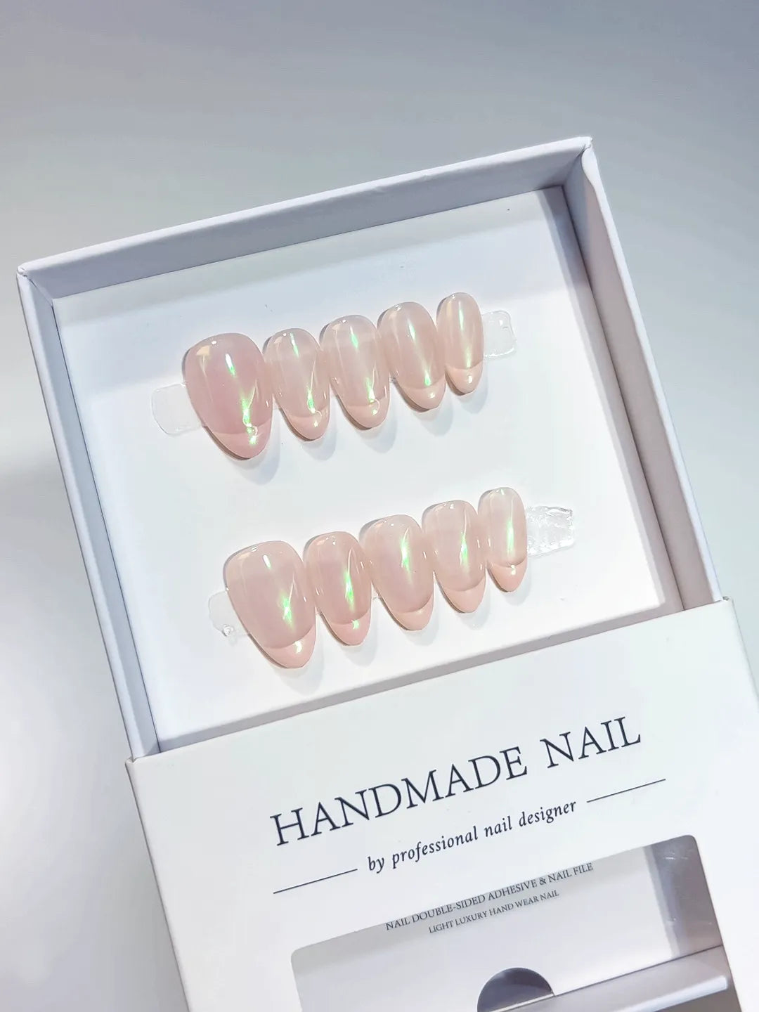 Handmade press on nails nude almond with green aurora shimmer, centerpiece view