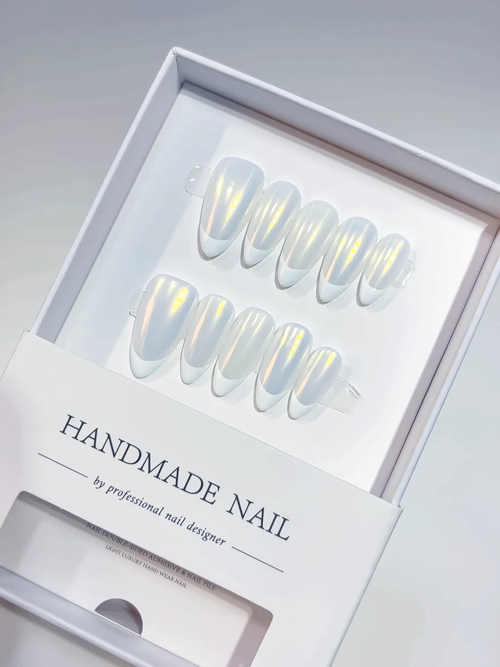 handmade press on nails medium almond white french with yellow aurora shine, angled view