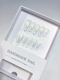 handmade press on nails medium almond white french with yellow aurora shine, angled view