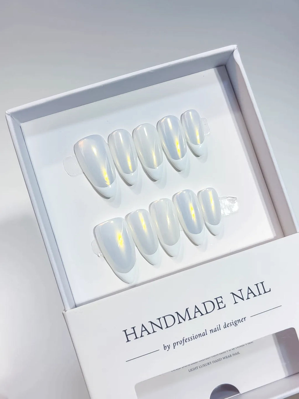 handmade press on nails medium almond white french with yellow aurora shine, angled view