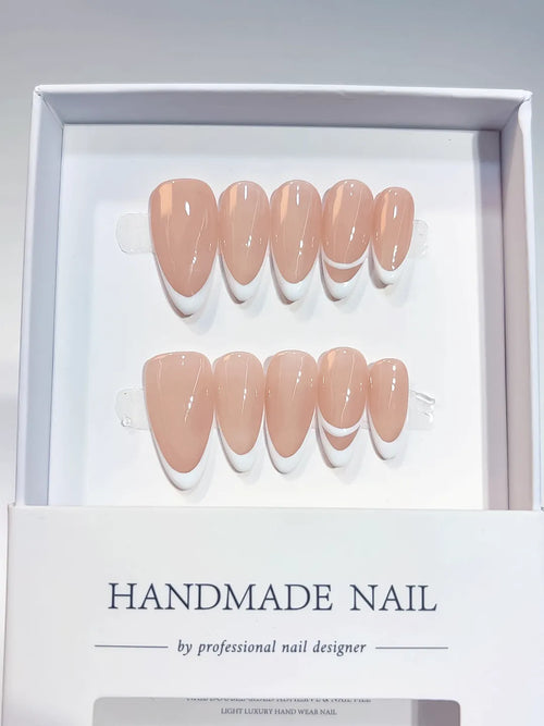handmade press on nails in nude french design with double line accent, close-up view
