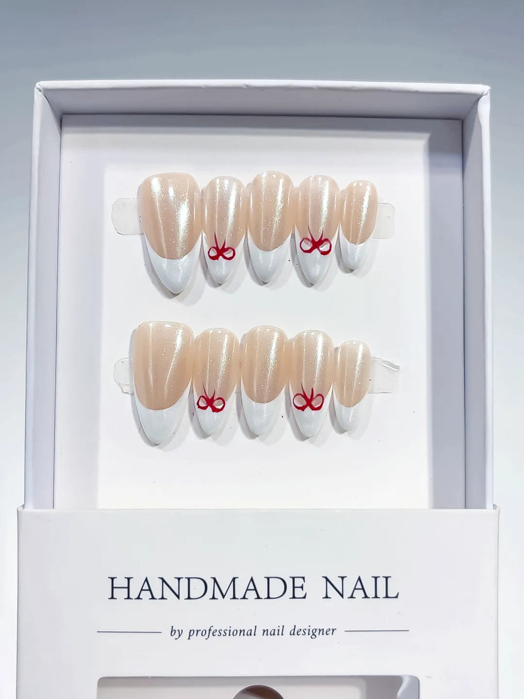 medium almond nude & white french with red bow accents, handmade press on nails centerpiece