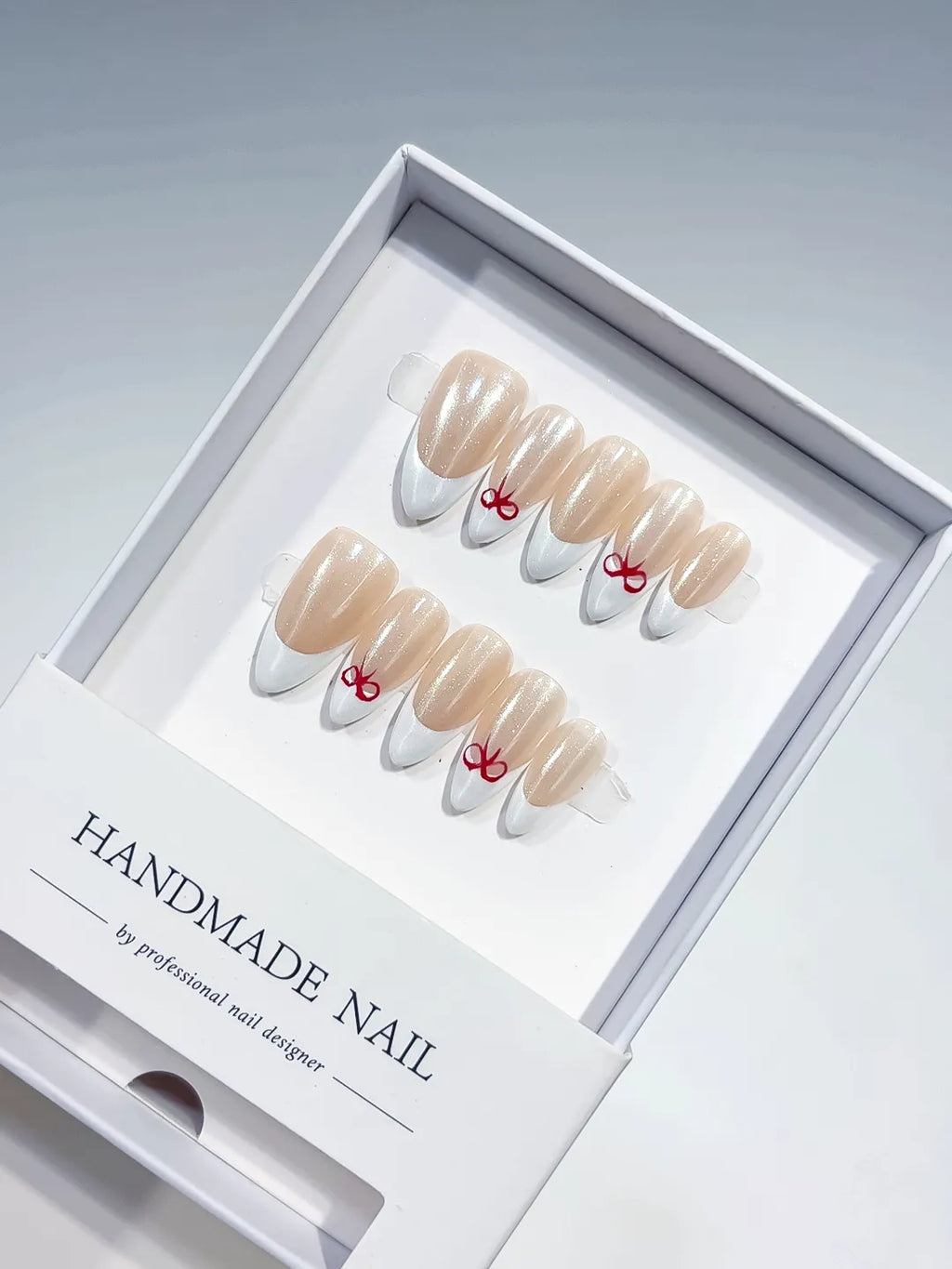 medium almond nude & white french with red bow accents, handmade press on nails centerpiece