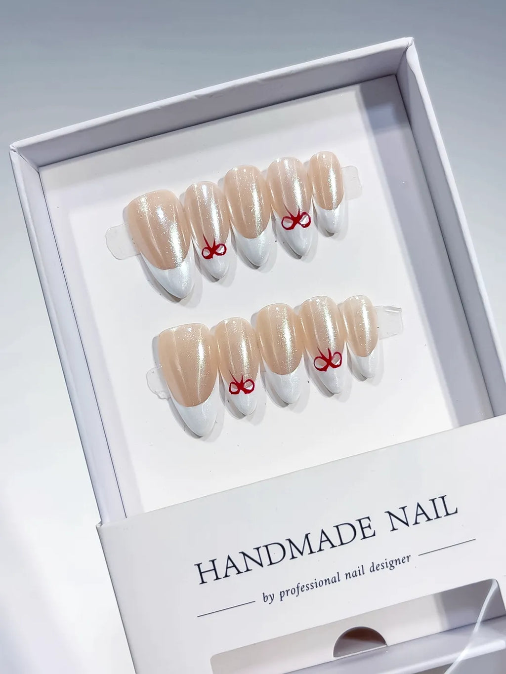 medium almond nude & white french with red bow accents, handmade press on nails centerpiece
