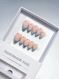 handmade press on nails, medium almond nude base with silver chrome french tips and 3D rhinestones, angled view